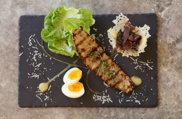 South African Caesar sals with cos lettuce, kudu biltong, a boiled egg and ciabatta and caeser dressing